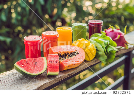 Rainbow from smoothies. Watermelon, papaya, mango, spinach and dragon fruit. Smoothies, juices, beverages, drinks variety with fresh fruits on a wooden table Rainbow from smoothies. Watermelon, papaya, mango, spinach and dragon fruit. Smoothies, juices, beverages, drinks variety with fresh fruits on a wooden table 92832871