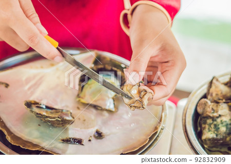 worker take the pearl from the shell worker take the pearl from the shell 92832909