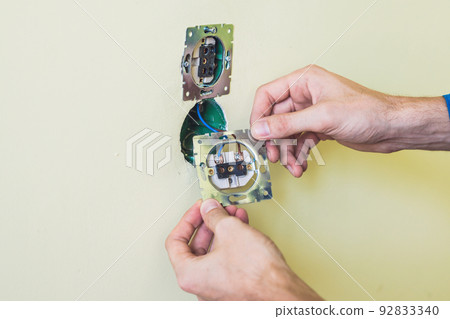 Electrician Installing Socket In New House Electrician Installing Socket In New House 92833340