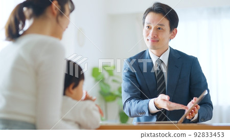 Male salesman who sells to mothers with children Male salesman who sells to mothers with children 92833453
