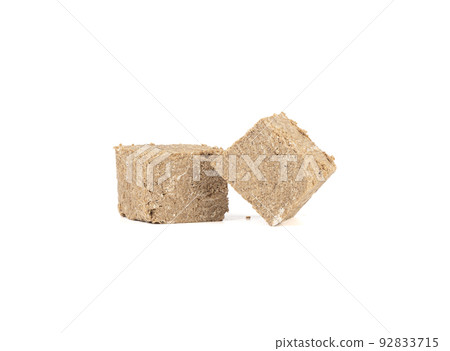 Two pieces of sweet sunflower halva on a white background. 92833715