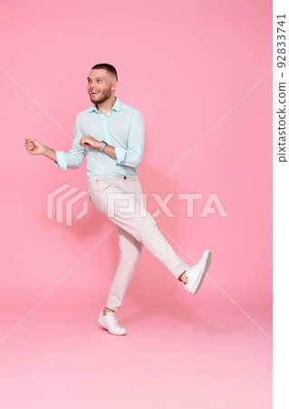 handsome smiling man in blue shirt dancing handsome smiling man in blue shirt dancing 92833741