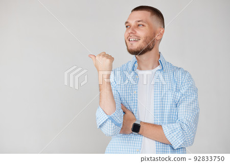 Young handsome bearded man pointing to the side 92833750