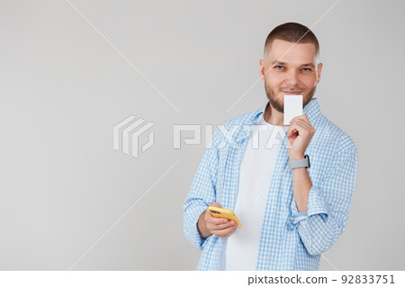 handsome man with smartphone and credit card handsome man with smartphone and credit card 92833751