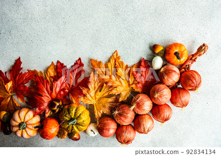 Fake maple leaves on the concrete background 92834134