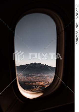 View of the mountain through the window of the plane. 92835422