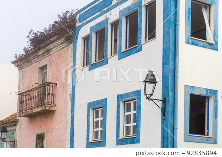 Two bright abandoned houses on a European street 92835894