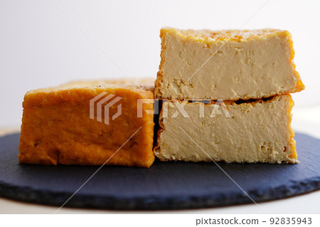 Sliced deep-fried tofu on a black plate Sliced deep-fried tofu on a black plate 92835943