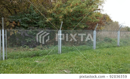 Barbed wire wall. Restricted area 92836359