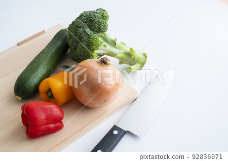 Cypress cutting board, kitchen knife and vegetables 92836971