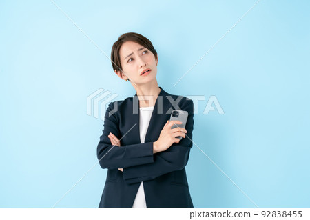 Smartphone worried business woman Smartphone worried business woman 92838455