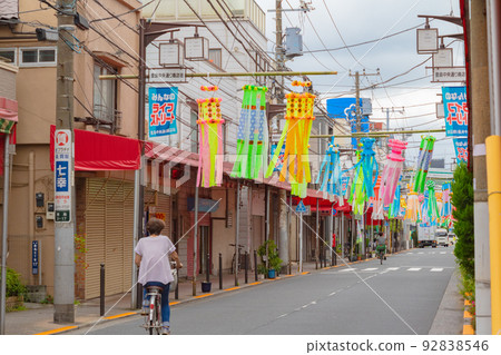 Oji, Kita Ward: Tanabata decorations and passers-by on bicycles at Teshima Shopping Street Oji, Kita Ward: Tanabata decorations and passers-by on bicycles at Teshima Shopping Street 92838546