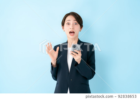 Smartphone surprised woman blue back 92838653