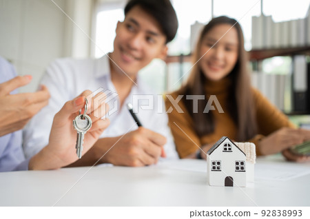 Client signs home loan document to buy homes with real estate property agent or lawyer. Real estate agent and customer signing contract to buy a house. Concept of insurance or loan real estate 92838993