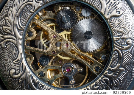The back side of a skeleton type pocket watch 92839569