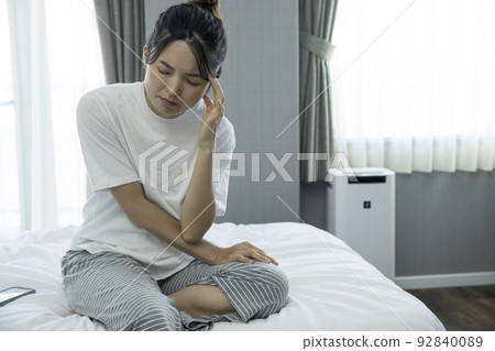 Young woman with headache after waking up 92840089