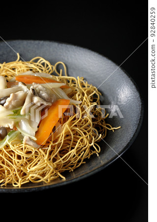 Sara-udon with bean paste containing shimeji mushrooms, carrots, onions, etc. photographed against a black background Sara-udon with bean paste containing shimeji mushrooms, carrots, onions, etc. photographed against a black background 92840259