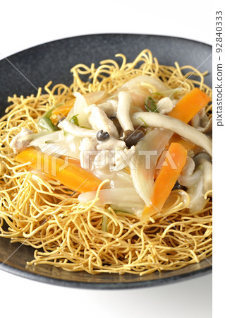 Sara-udon with bean paste containing shimeji mushrooms, carrots, and onions, photographed against a white background Sara-udon with bean paste containing shimeji mushrooms, carrots, and onions, photographed against a white background 92840333