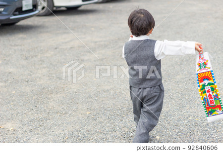 A boy holding Chitose candy at a shrine Shichigosan 92840606