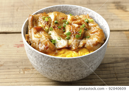 Teriyaki chicken rice bowl with a large piece of chicken on top of an egg Teriyaki chicken rice bowl with a large piece of chicken on top of an egg 92840609