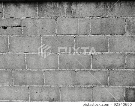 Close-up of White cement crack block wall and peeled paint caused by water and sunlight. Peel wall of White house paint with black stain. Black and White of Texture background. Close-up of White cement crack block wall and peeled paint caused by water and sunlight. Peel wall of White house paint with black stain. Black and White of Texture background. 92840690