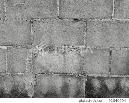 Close-up of White cement crack block wall and peeled paint caused by water and sunlight. Peel wall of White house paint with black stain. Black and White of Texture background. 92840694