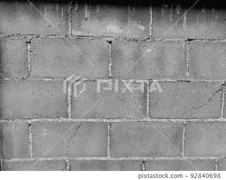 Close-up of White cement crack block wall and peeled paint caused by water and sunlight. Peel wall of White house paint with black stain. Black and White of Texture background. 92840698