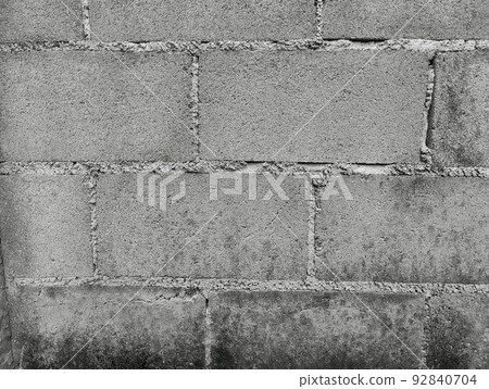 Close-up of White cement crack block wall and peeled paint caused by water and sunlight. Peel wall of White house paint with black stain. Black and White of Texture background. 92840704