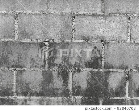 Close-up of White cement crack block wall and peeled paint caused by water and sunlight. Peel wall of White house paint with black stain. Black and White of Texture background. 92840708