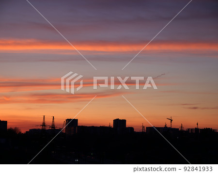 Beautiful bright sunset sky over building silhouettes Beautiful bright sunset sky over building silhouettes 92841933