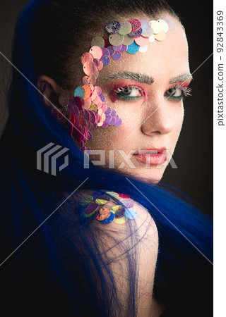 Portrait of a girl with colorful sequins makeup 92843369
