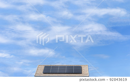 [Environmental image] The roof of a house with solar panels installed and a clear blue sky. 92843619