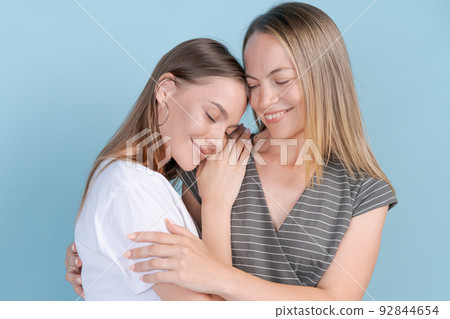 Close up photo amazing cute two people mom and daughter stand hugging each 92844654