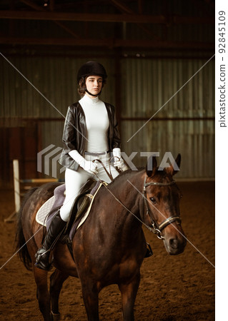 Young woman rider on dressage horse. An abstract shot of horse during Young woman rider on dressage horse. An abstract shot of horse during 92845109