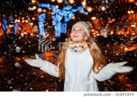 teenage girl on a festive evening on the street in winter 92845954