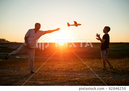 Soft focus of father and son playing toy airplane Soft focus of father and son playing toy airplane 92846250