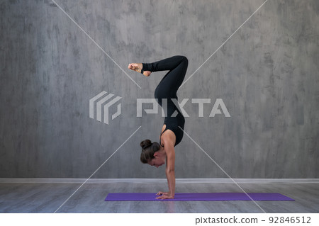 Side view portrait beautiful young woman wearing black sportswear, exercising Side view portrait beautiful young woman wearing black sportswear, exercising 92846512