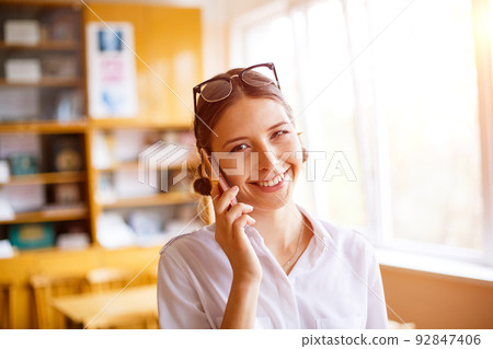 Young female student in white shirt in school class, youth education Young female student in white shirt in school class, youth education 92847406