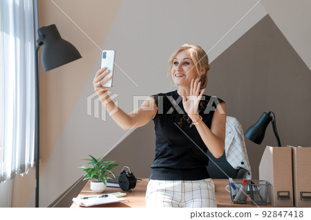 Share good business news. Attractive young woman talking on mobile phone via 92847418