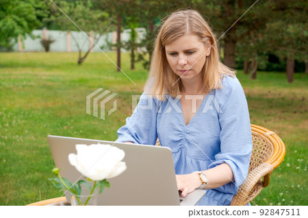 Freelancing, digital nomad and nature concept. Attractive woman preparing work Freelancing, digital nomad and nature concept. Attractive woman preparing work 92847511