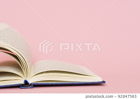 Open book page closeup on pink background, back to school education concept. 92847563