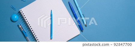Notebook and pen on a blue background. Top view with copy space. Stationery Notebook and pen on a blue background. Top view with copy space. Stationery 92847700