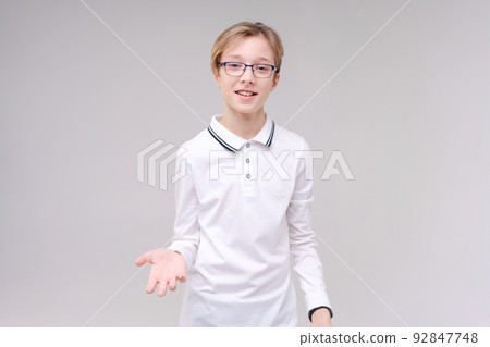 Portrait handsome caucasian boy in glasses who just has an idea points his 92847748