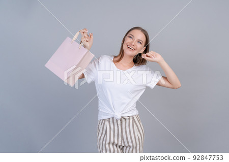 Seasonal sales and purchases. Portrait adorable happy female consumer walking 92847753