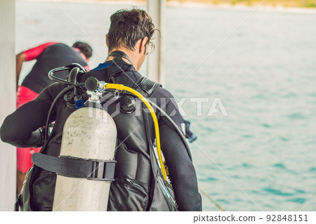 Happy diver returns to the ship after diving 92848151
