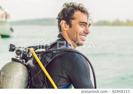 Happy diver returns to the ship after diving Happy diver returns to the ship after diving 92848153