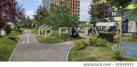 children's playground in a modern residential complex of apartment buildings children's playground in a modern residential complex of apartment buildings 92848955