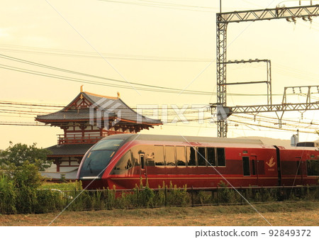 "Limited Express Hinotori" of Kintetsu Line running in front of Suzakumon, which was restored to the site of the World Heritage Heijo Palace 92849372
