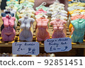 Scented candles as human bodies in a display case 92851451