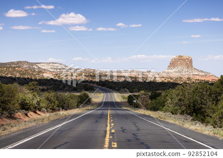 Scenic Road in the Dry Desert with Red Rocky Mountains in Background. Scenic Road in the Dry Desert with Red Rocky Mountains in Background. 92852104